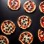 Placeholder: Photo of 4 pizzas, black background