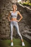 Placeholder: beautiful anorexic woman, standing, grey satin capri yoga leggins, short grey satin yoga top, medium length wavy haircut, slim chest, thin lips