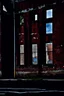 Placeholder: side of an old brick building, with windows, a doorway at the bottom, and across the top is a worn out painted mural