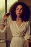 Placeholder: A beautiful woman with curly brown hair, a pensive expression, holding in one hand an old dial phone with the cord wrapped around her body, in a luxurious room in sunshine