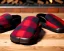 Placeholder: Red plaid slippers, black bearskin rug,log cabin, stone fireplace