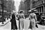 Placeholder: in 1920 two women walking down the street beside each other in nice dresses and hats in New York, Madison Square, high quality, intricate details, realistic