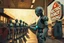 Placeholder: A cinematic wide-angle oil painting of a humanoid robot plugging a thick electric charging cable into its torso port at a futuristic charging station within a retro-style gas station. A long line of identical humanoid robots stands patiently behind, waiting for their turn to recharge. A large vintage-style sign to the side reads 'Electric Robot Charging Station.' The scene is bathed in golden-hour lighting, with rich, noisy colors, expressive thick brushstrokes, intricate steampunk elements, glo