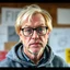Placeholder: cool blonde hair blonde eyes guy 55 years old rodfessor big fat, smart,,, film maker director,,, wearing glasses yound in a hoody talking about philiophy ton his friends, style life realism