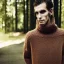 Placeholder: a full picture of a tall skinny man with light and greasy hair wearing a woolen sweater outside in nature