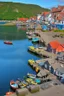 Placeholder: medieval fishing town, rocks, long piers, fishing boats, shops, blue sky