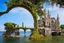 Placeholder: A futuristic ruined gothic building on an island floating over the sea with balconies, verandas, many arches, bridges, spires, paths, trees, dense foliage, spanish moss, ivy, blue sky, white clouds