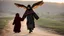 Placeholder: A Palestinian girl have tow wings wearing an old dress in gaza during sunset in winter.