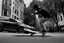 Placeholder: a black and white photo of a man on a skateboard in front of a, inspired by Jens Søndergaard, a screenshot, featured on dribble, digital screenshot, dutch camera view, chasing a robber down a street, screenshots, video, still from a music video, odd, unsettling, absurd, glitch deconstruction