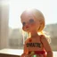 Placeholder: doll melting in sunlight, dripping, with the French word "DISPARAÎTRE" on the doll, dazzling sun, ytopical heatwave