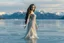 Placeholder: in a frozen sea with pretty mountains a full model lady statue with long curvy hair made and midi jeweled dress of frozon water in artist pose standing over frozon water looking at camera, of clear glass like ice that going to melt and water drops fall from all body.