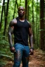 Placeholder: Alimi Ballard as muscular man bald with tribal tattoos wearing jeans and a teeshirt in a forest