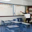 Placeholder: Classroom, teacher and white board.