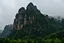 Placeholder: edge of a rocky mountain plateau ahead cliff it's raining dark below jungle