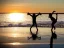 Placeholder: children jumping in water on a beach capture them against the sun and make an art silhouette, hyper details, real sharp, 8k, well detailed, well shaped