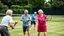 Placeholder: Elderly pensioners playing tennis doubles on a grass court. Everyone is happy. Photographic quality and detail, award-winning image, beautiful composition.