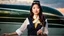 Placeholder: A gorgeous Asian model in an air hostess uniform looking out of the window at sunset