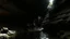 Placeholder: dark rock cave, looking upward as the cave continues upward. A stream runs down the the left side, lined by a small dam, in the style of jordan grimmer