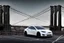 Placeholder: A Tesla's 'Model S' is parked, on the 'Brooklyn Bridge' in New York. CINEMATIC. WIDE ANGLE LENS. PHOTO REAL.