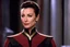 Placeholder: her Bajoran typical series of horizontal creases across her noses: Nana Visitor as Kira Nerys for the first time, your attention is immediately drawn to her uniform, emblazoned with the emblem of the Bajoran Militia. The black fabric is crisp and clean, accentuating the lean, muscular lines of her body. The gold trimmings that adorn the collar, cuffs, and pockets give the uniform a sense of formality and authority.