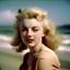 Placeholder: A colored photograph of marilyn monroe as norma jeane baker with long blond hair, , in the style of Andréde Dienes, at the beach, in the wind