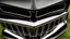 Placeholder: Photograph of a the front grill of a gorgeous, expensive, oldschool black muscle car with a big, black front grill, realistic, stylish, taken up close, symmetrical