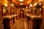 Placeholder: Pictures of a group of bathrooms in Mathaf Restaurant. The walls and floors are colored in brown tones