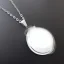 Placeholder: Clear polyester necklace with a chunky silver pendant in the shape of a key