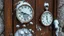 Placeholder: A melted clock hanging precariously on a rusty iron door, delicate thistles emerging from the cracks, scene set in a snowy winter landscape with a light dusting of snow on the clock and door.