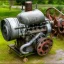 Placeholder: Old, small, rusty, single-cylinder engine