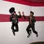 Placeholder: MR Kukrunk is Benny and DJ Roy in a disco, dancing, Kukrunk on wall