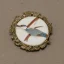 Placeholder: ivory brooch of a kingfisher, decorative design, classical ornament, highly ornate, highly intricate, highly detailed etching, marble carving, warm lighting