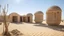 Placeholder: An architectural work located in a desert oasis at midday, depicting roughly hewn vertical stone posts supporting adobe-style cubicles and mirage-like spheres, with a heat haze rising from the sand.