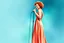 Placeholder: full figure, red curly hair upswept gorgeous singer on a stage in front of a microphone, sleeveless rose gold shiny silk long dress, the dress goes down to bluish green, photorealistic watercolour