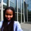 Placeholder: A long haired, black female software engineer taking a selfie in front of Building 92 at Microsoft in Redmond, Washington