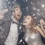 Placeholder: A couple partying with silver confetti