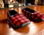 Placeholder: Red plaid slippers, bear rug,log cabin, stone fireplace