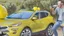 Placeholder: guy arguing on phone next to kia sportage covered with lemons