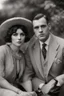 Placeholder: Up close Black and white photo of a serious couple sitting for portrait shoot in the 1920s