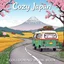 Placeholder: Create a book cover for "Cozy Japan Coloring Book" showcasing a charming countryside road trip scene with a small, vintage camper van winding along a scenic road. In the distance, Mount Fuji rises majestically, partially veiled by soft clouds and framed by blooming cherry blossoms and golden rice fields. The van is adorned with travel stickers and roof luggage, while a cat peeks out the window. The atmosphere is peaceful and nostalgic. Illustration, warm pastel palette with soft shading and fine