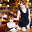 Placeholder: Realistic photo Russian shorthair beautiful 20-years tomboy boyish boylike young wife wide hips in restaurant with little daughter