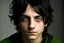 Placeholder: a young male with messy black hair and green eyes