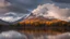 Placeholder: Big autumn clouds were moving around the mountain As dusk approaches, big clouds spread over the lake, but the majestic mountain is clearly visible.