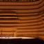 Placeholder: a single chair on stage under spotlight at an empty symphony hall