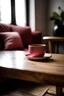 Placeholder: image of a wooden table with a pink pillow on it and a coffee mug on the other side, the pillow in the foreground