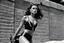 Placeholder: [photo by helmut newton in agent provocateur on the arena] Her complexion, after years spent training under the sun, bore the mark of a warrior who had weathered countless battles. Though her face spoke of hardship, there was also an air of grace and serenity that emanated from her every pore. Selene's physique was a testament to her dedication and discipline. Her muscular frame hinted at her physical prowess, yet her movements were fluid, as if she danced with the wind itself.