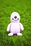 Placeholder: plush toy(tall and skinny blob with 1 eye and a smile) small feet at front, in a field of short grass