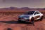 Placeholder: A Tesla 'Model Y' is parked, in the Mojave Desert. (CINEMATIC, WIDE ANGLE LENS, PHOTO REAL)