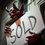 Placeholder: A realistic ghoulish laughing devil leaning forward at an angle as if over someone's shoulder, facing right, holding a large sign that says "SOLD" in clear letters. No humans, no extra subjects, cinematic horror lighting.