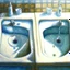 Placeholder: two white sinks, in one of them water is turning right and in the other lef, art, oil drawing, bright,